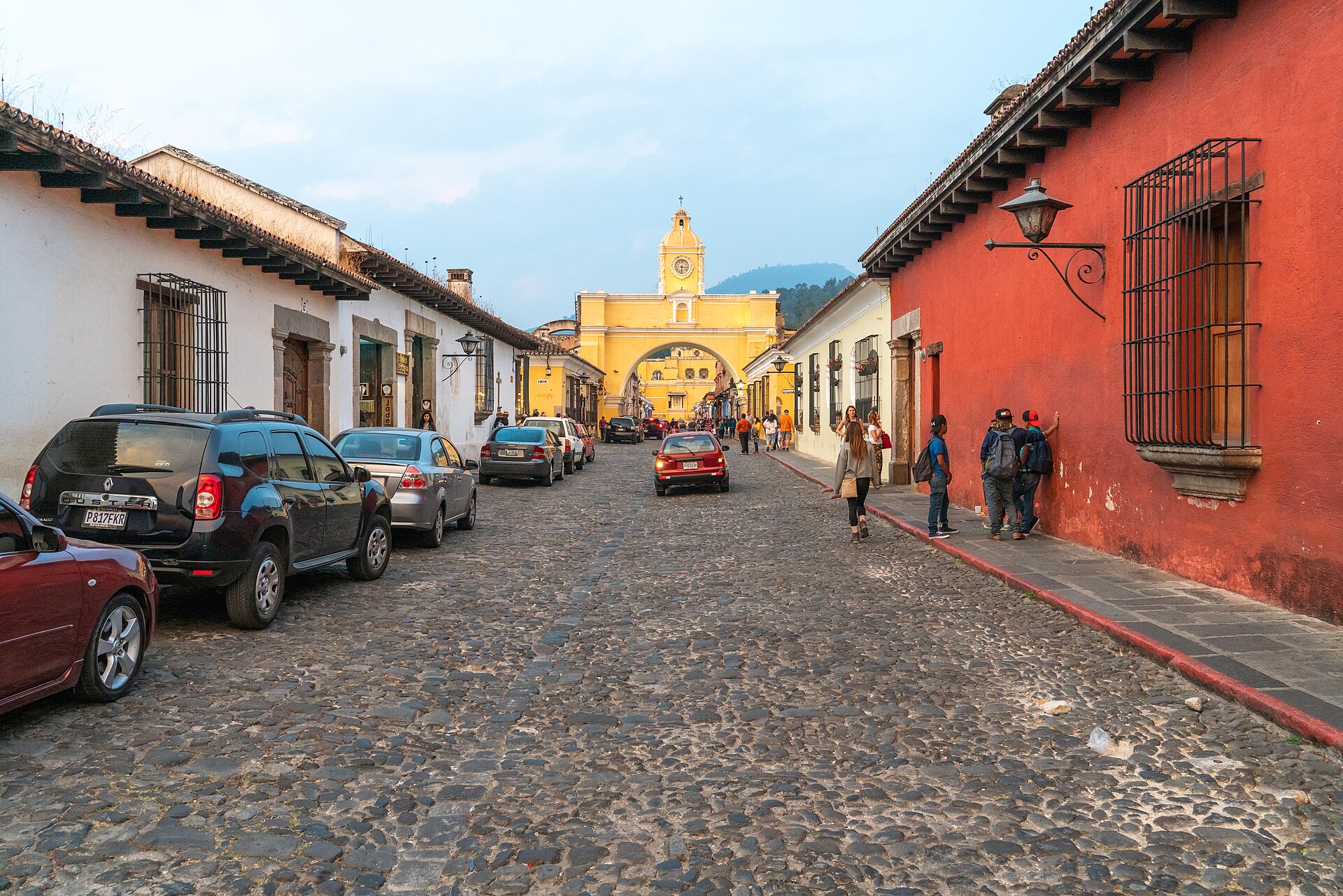 The yellow Santa Catalina Arch above a cobblestone street in Antigua Guatemala
