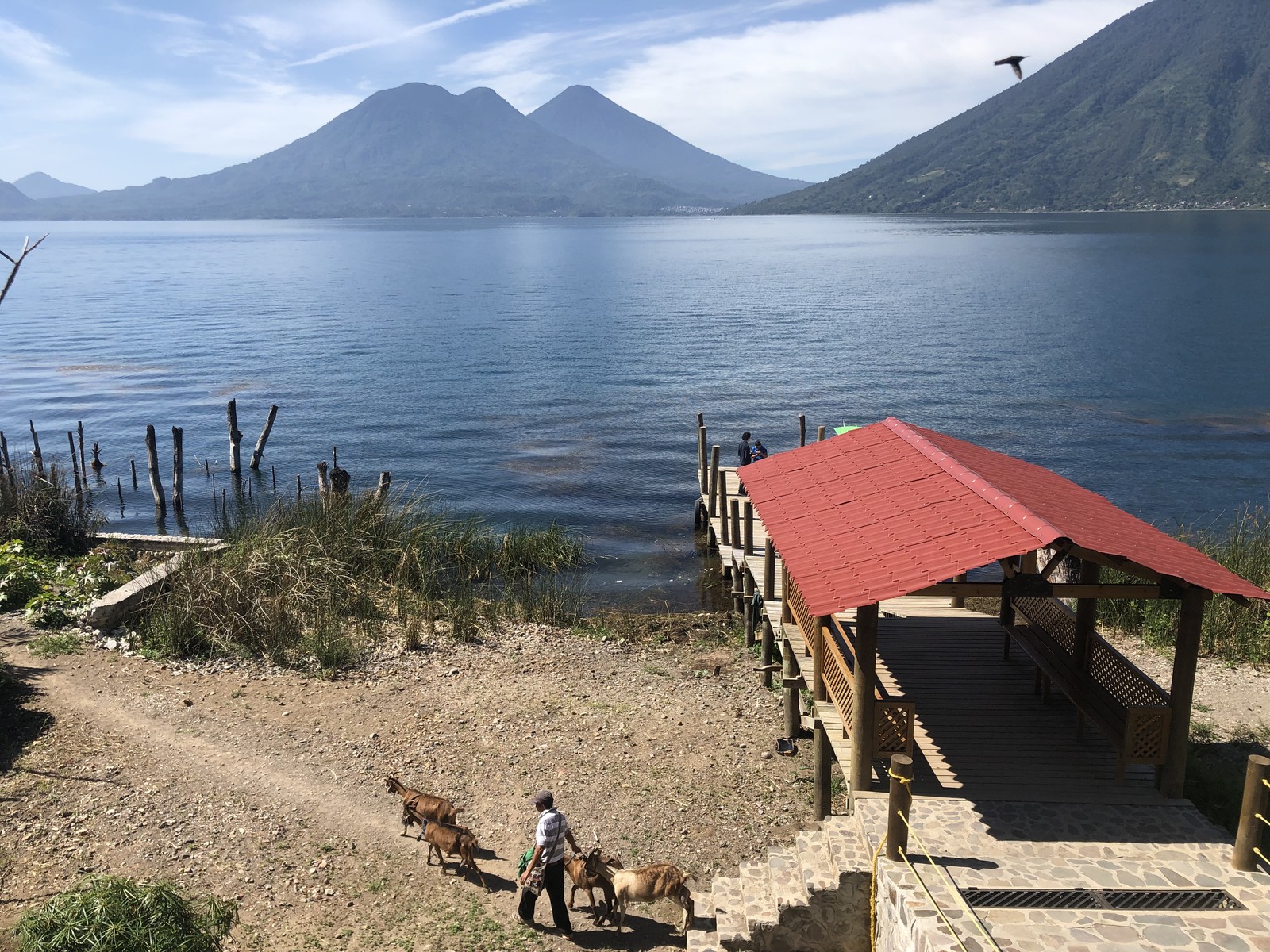 A covered dock at San Marcos La Laguna overlooks Lake Atitlán and the volcanic landscape across the water.