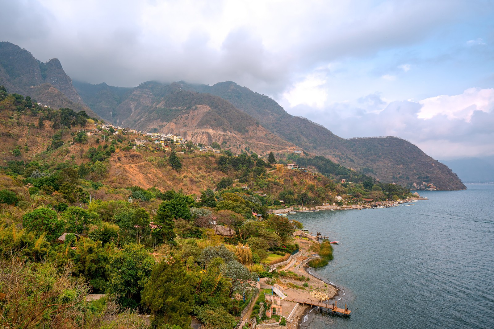 Santa Cruz La Laguna’s village and lakeside docks sit below steep hills on the shore of Lake Atitlán.