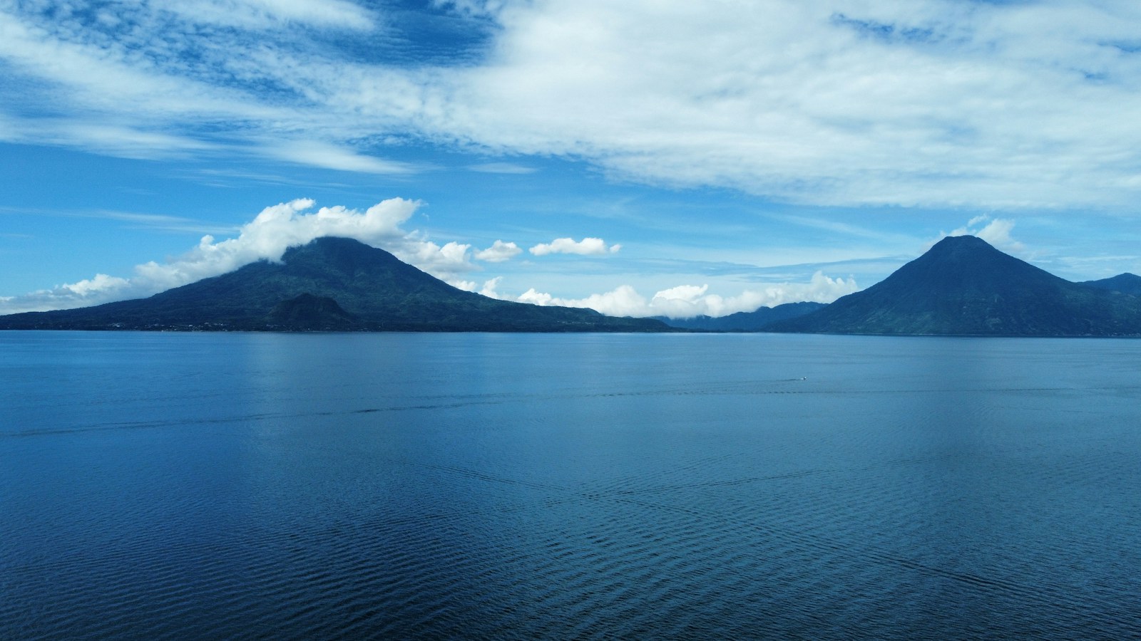 Lake Atitlán with volcanoes beyond the water in Guatemala